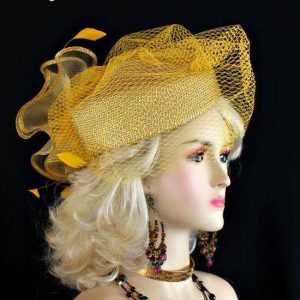 <META NAME="DESCRIPTION" CONTENT="Ladies Metallic Gold Designer Pillbox Fashion Hat With A Birdcage Veil By NY Fashion Hats. We specialize in pillbox hats for weddings