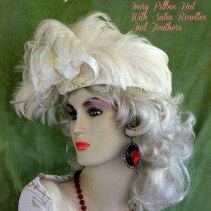 <META NAME="DESCRIPTION" CONTENT="Ladies Ivory Pillbox Wedding Hat With Satin Rosettes Organza Feathers By www.NYFashionHats.Com - We sell elegant ivory Church hats with roses